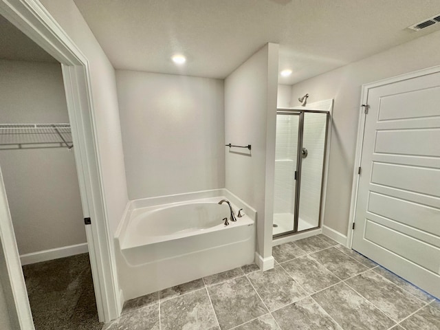 bathroom featuring tile patterned flooring and shower with separate bathtub