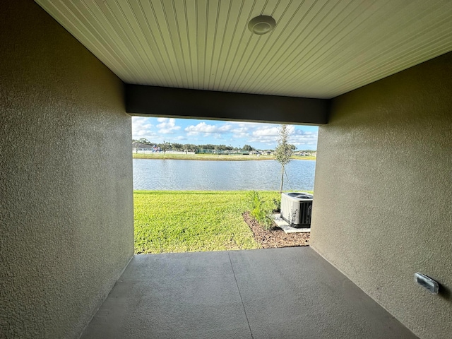 view of patio / terrace with a water view and central AC