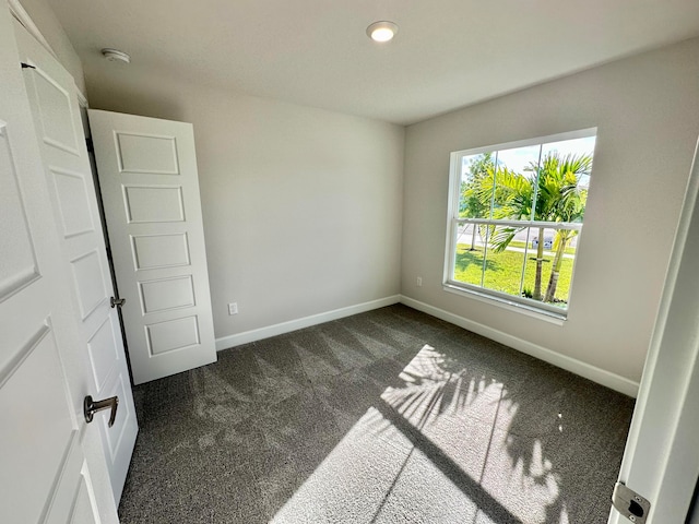 unfurnished bedroom featuring dark colored carpet