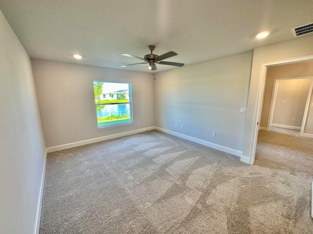 carpeted empty room featuring ceiling fan