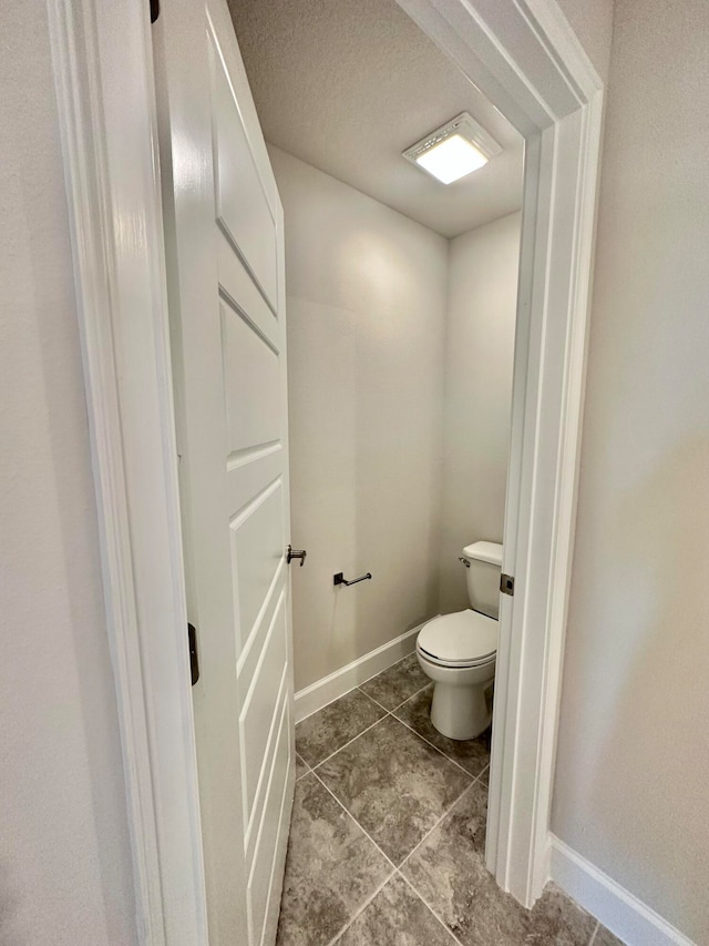 bathroom with tile patterned floors and toilet