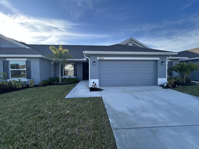 ranch-style house featuring a front yard and a garage