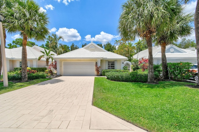 view of front facade with a garage and a front lawn