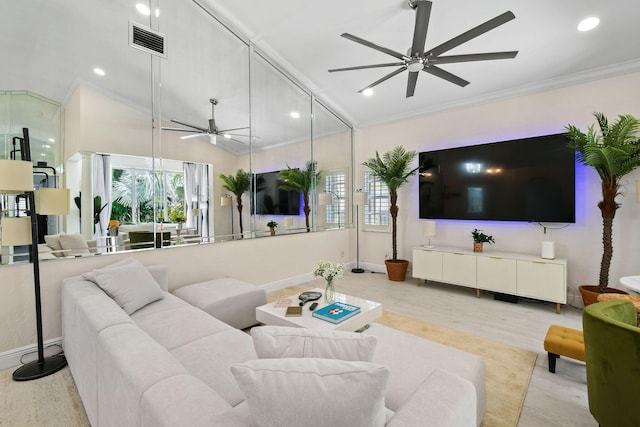 living room featuring lofted ceiling, light wood-type flooring, ceiling fan, and crown molding