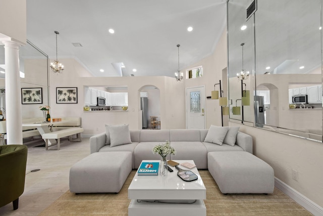 living room featuring light hardwood / wood-style flooring, lofted ceiling, and a notable chandelier