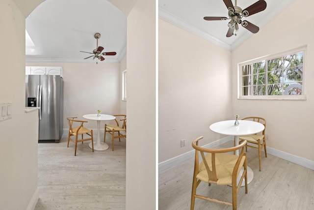 dining room with light wood-type flooring, vaulted ceiling, ceiling fan, and crown molding