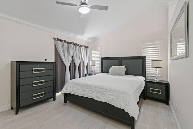 bedroom with multiple windows, vaulted ceiling, and light wood-type flooring