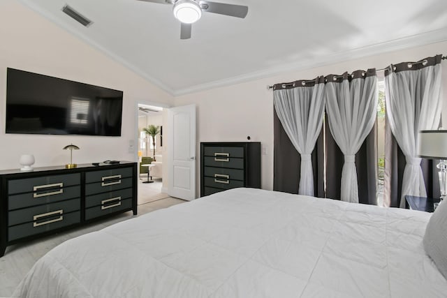 bedroom with ceiling fan, lofted ceiling, and ornamental molding