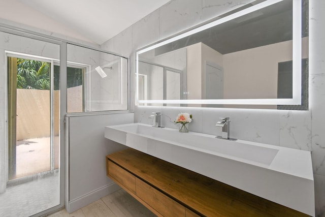 bathroom featuring tile walls, vanity, an enclosed shower, and vaulted ceiling