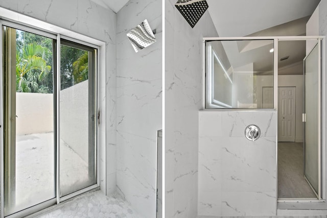 bathroom with lofted ceiling and tiled shower