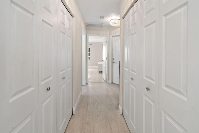 corridor with light wood-type flooring