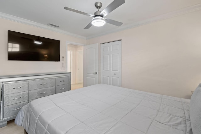 bedroom with a closet, ceiling fan, and ornamental molding