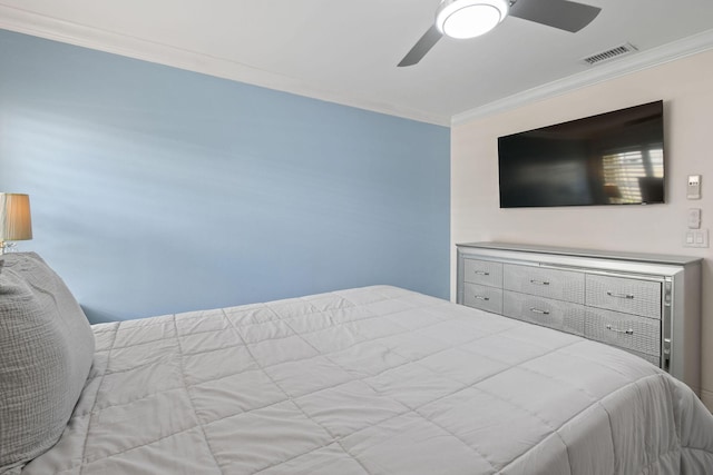 bedroom with ceiling fan and crown molding