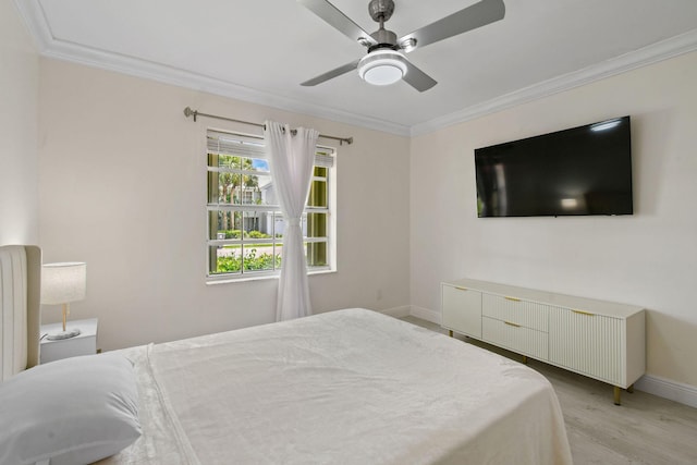 bedroom featuring light hardwood / wood-style floors, ceiling fan, and ornamental molding