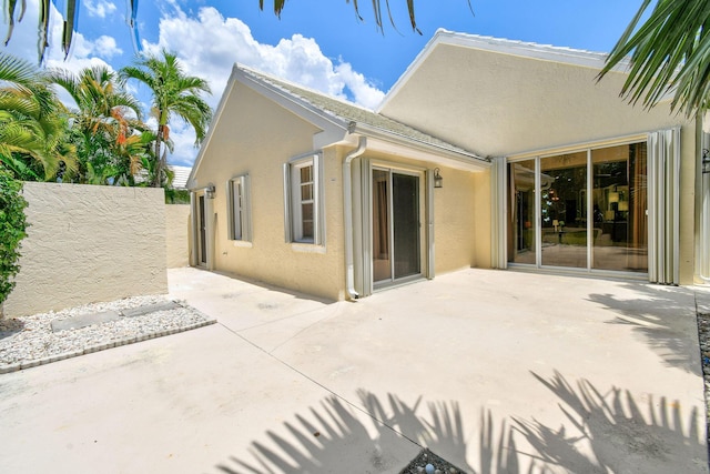 back of property with a patio