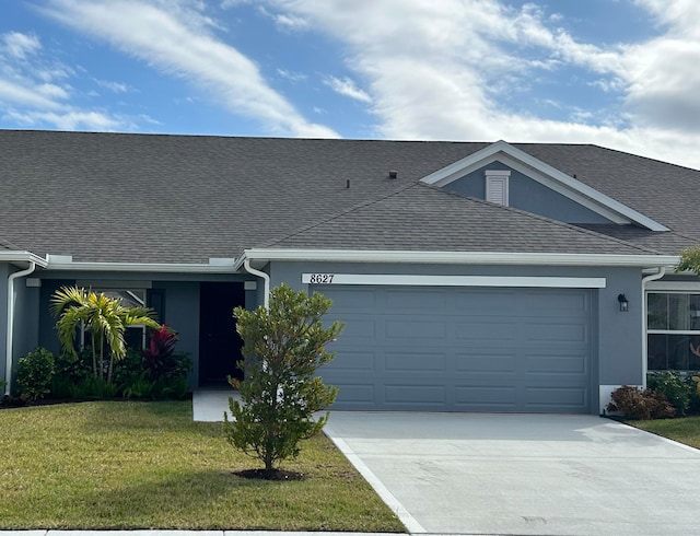 ranch-style house featuring a front yard and a garage