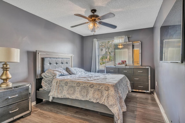 bedroom featuring a textured ceiling, ceiling fan, and dark hardwood / wood-style floors