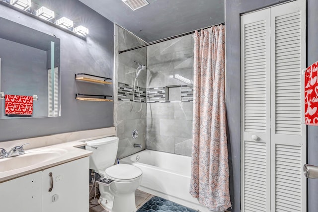 full bathroom featuring tile patterned flooring, vanity, toilet, and shower / bathtub combination with curtain