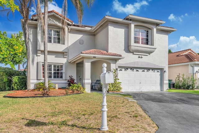 mediterranean / spanish-style house with a front yard and a garage