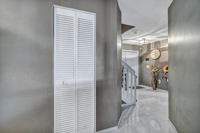 hallway featuring a textured ceiling