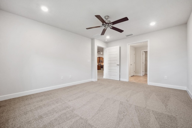 unfurnished bedroom featuring ceiling fan and light carpet