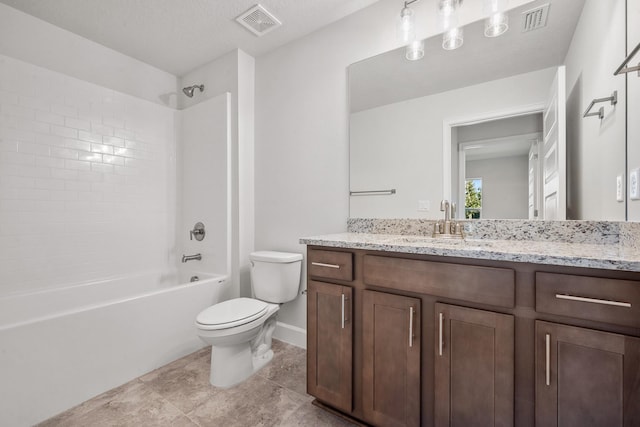 full bathroom with a textured ceiling, vanity, tile patterned flooring, toilet, and tiled shower / bath