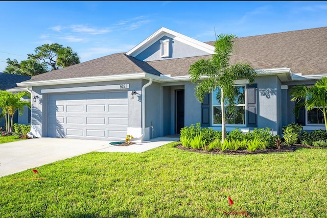 ranch-style home featuring a garage and a front lawn