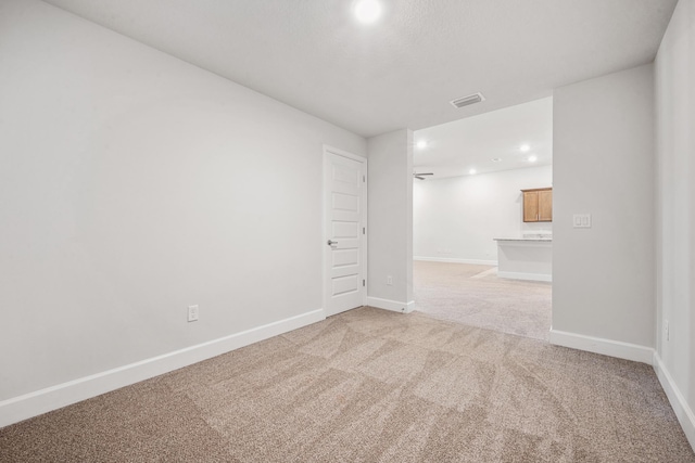 empty room featuring light colored carpet