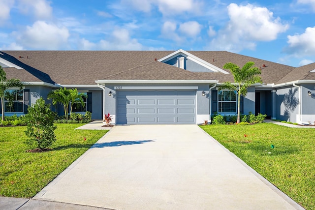 ranch-style house featuring a garage and a front lawn