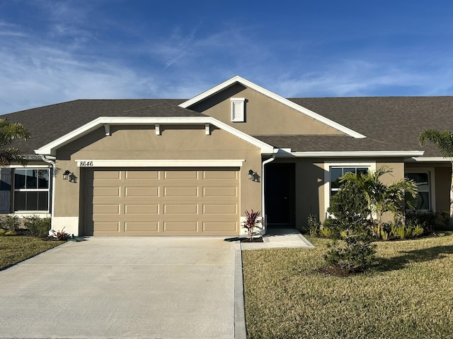 view of front of property featuring a front yard and a garage