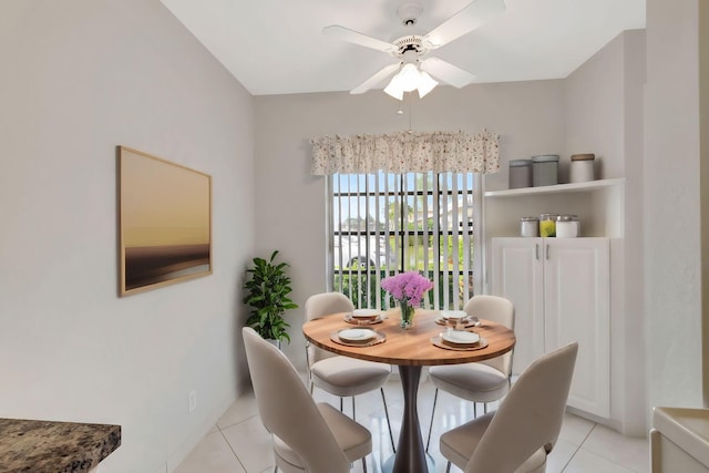 tiled dining room featuring ceiling fan