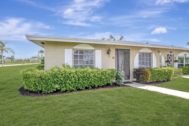 ranch-style home with a front yard