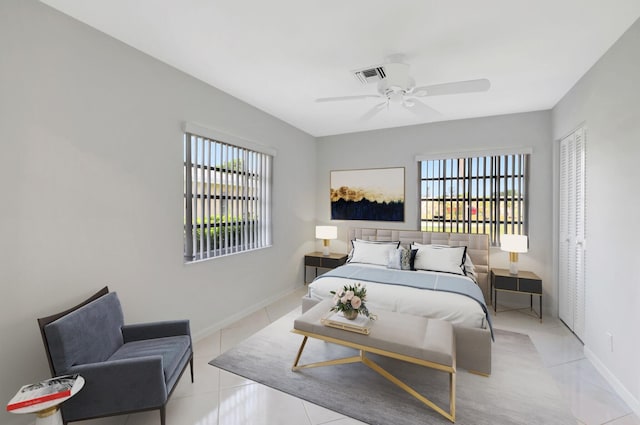 tiled bedroom with ceiling fan