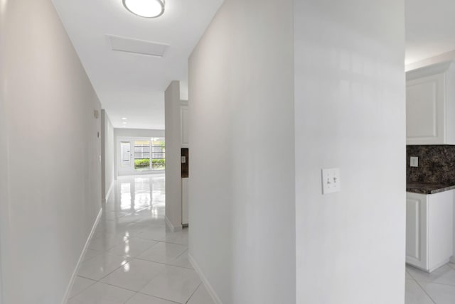 hall with light tile patterned floors