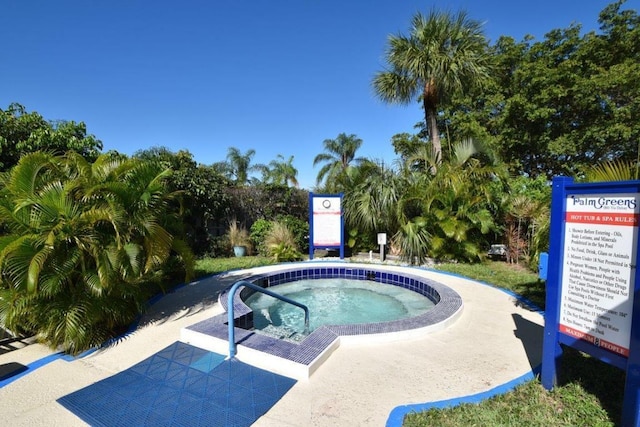 view of swimming pool featuring a community hot tub