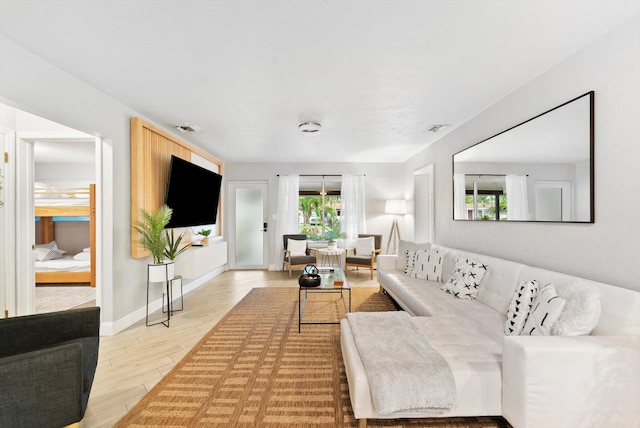 living room featuring a wealth of natural light and light hardwood / wood-style flooring