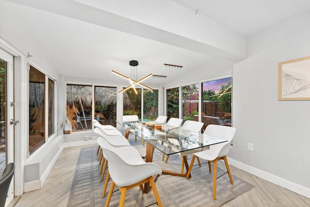 sunroom with lofted ceiling and a notable chandelier