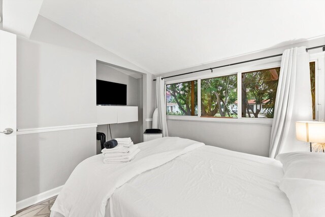 bedroom featuring vaulted ceiling