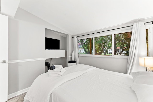 bedroom with lofted ceiling