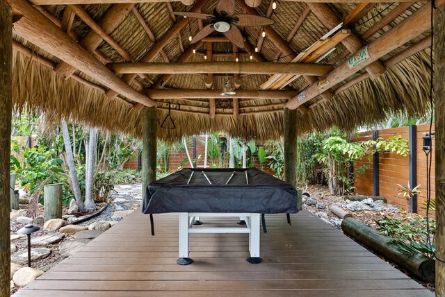 wooden terrace featuring ceiling fan and a gazebo