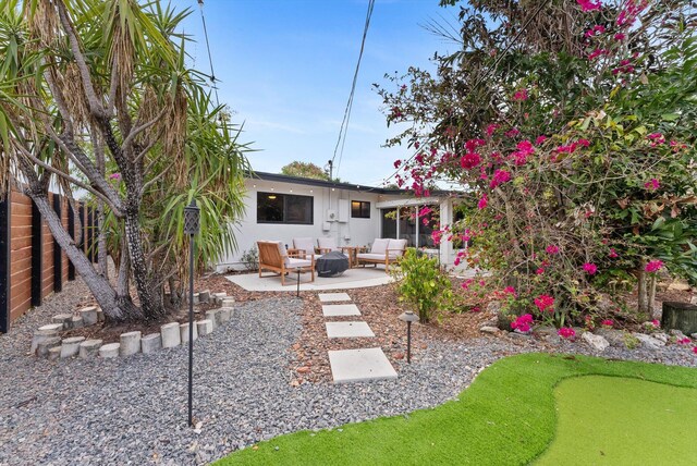 rear view of property with an outdoor hangout area and a patio area