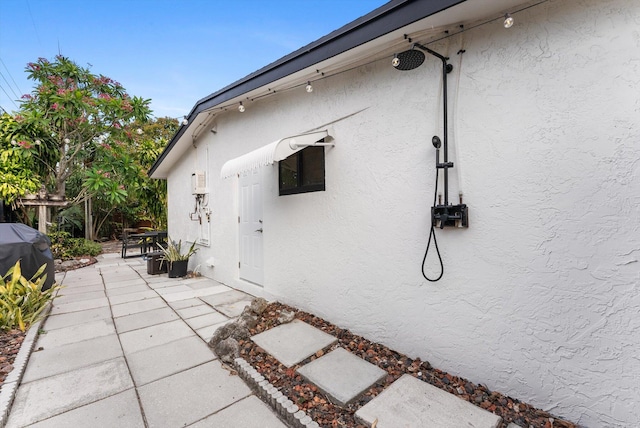 view of side of property with a patio