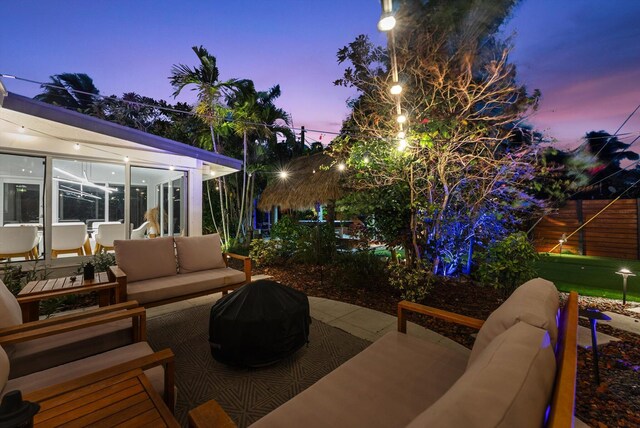 patio terrace at dusk featuring an outdoor hangout area