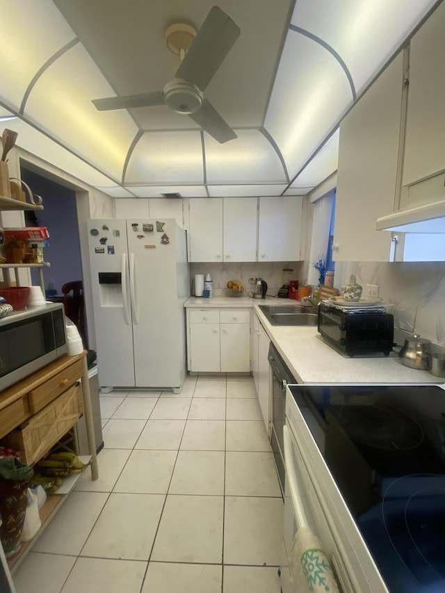 kitchen with ceiling fan, tasteful backsplash, white cabinetry, white refrigerator with ice dispenser, and light tile floors