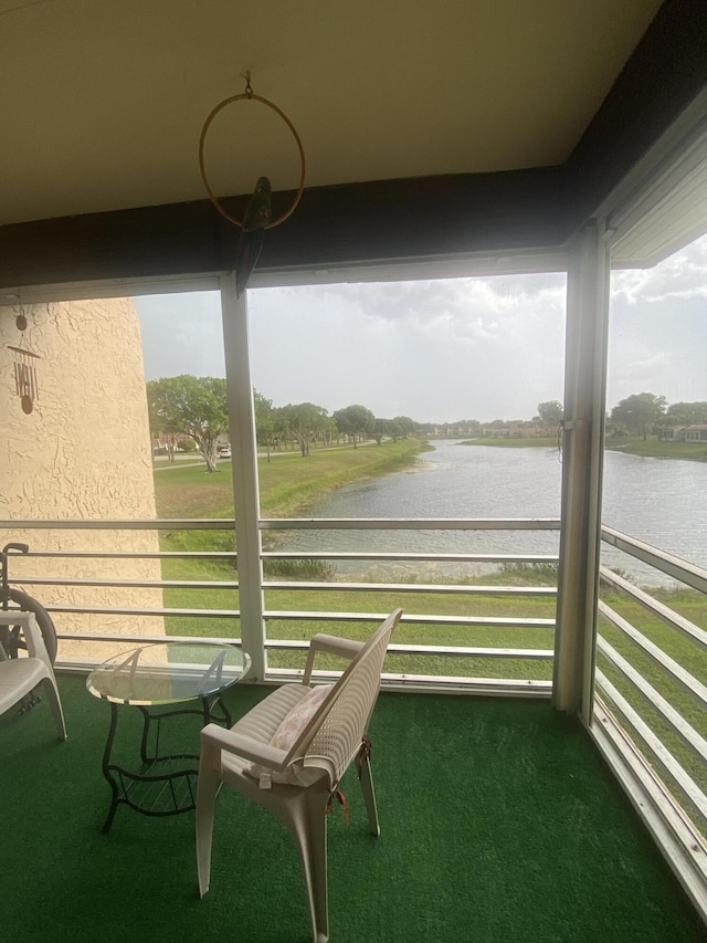 view of patio / terrace featuring a balcony and a water view