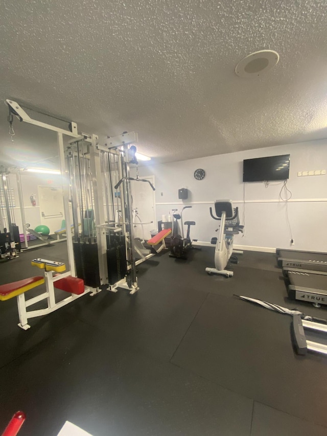 workout area featuring a textured ceiling