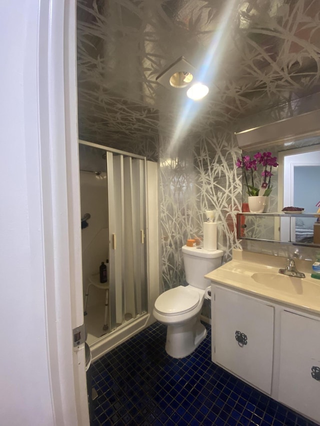 bathroom featuring tile flooring, walk in shower, vanity, and toilet