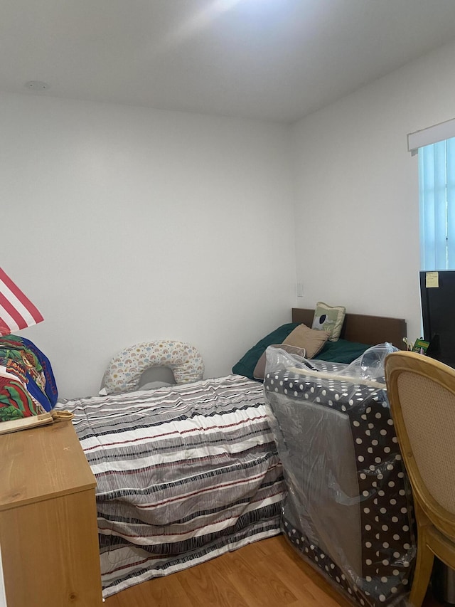 bedroom with wood-type flooring