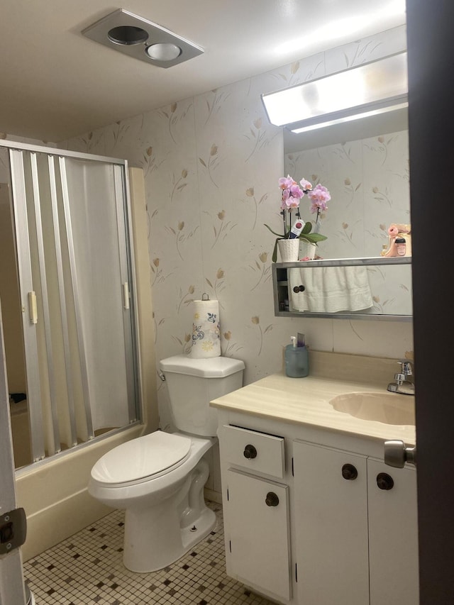 full bathroom featuring tile flooring, bath / shower combo with glass door, toilet, and vanity