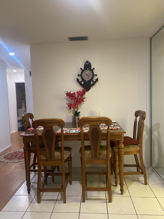 dining area featuring light tile floors